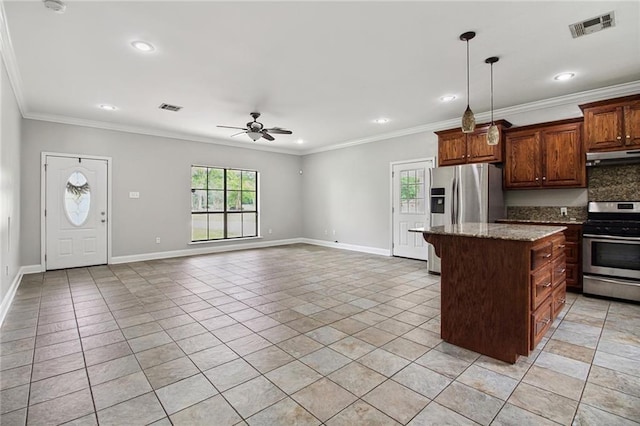 44449 W Pleasant Ridge Rd, Hammond, LA 70403 - kitchen with stainless steel appliances, visible vents, under cabinet range hood, a wealth of natural light, and a center island