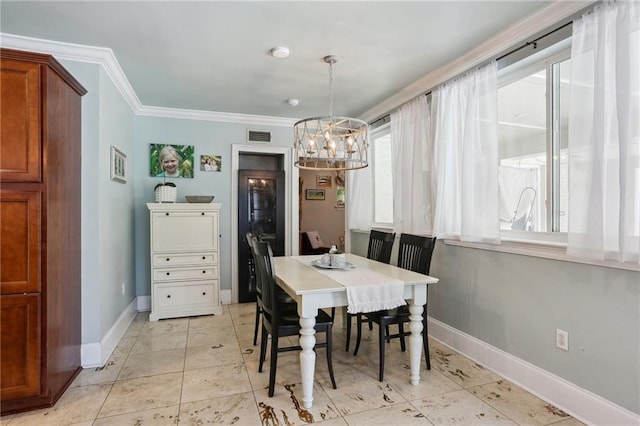 3537 Thrasher St, New Orleans, LA 70124 - dining space with a chandelier, ornamental molding, healthy amount of natural light, baseboards, and light tile patterned floors