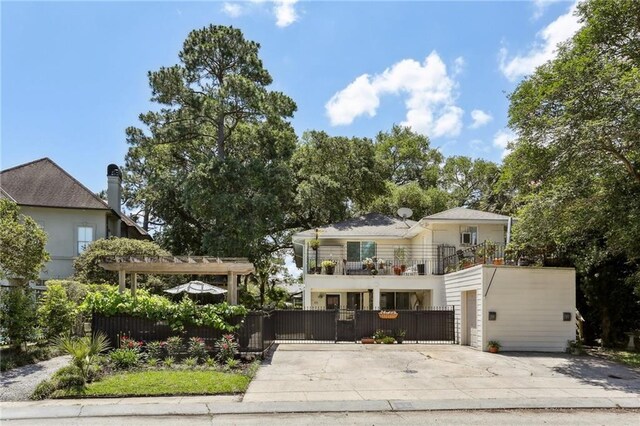 3537 Thrasher St, New Orleans, LA 70124 - view of front of property with a balcony, a fenced front yard, driveway, a gate, and a garage