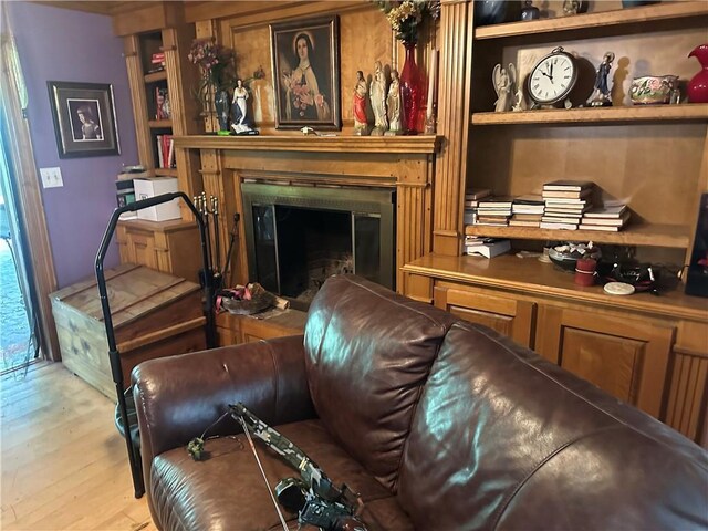 41139 Happywoods Rd, Hammond, LA 70403 - living room featuring built in features, wood finished floors, and a glass covered fireplace