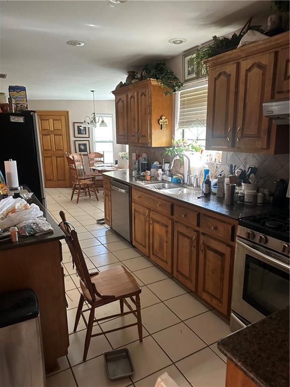 41139 Happywoods Rd, Hammond, LA 70403 - kitchen with a sink, dark countertops, plenty of natural light, and appliances with stainless steel finishes