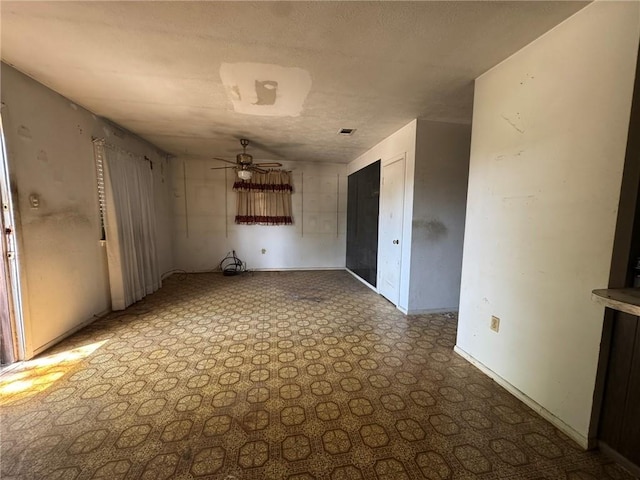 spare room with a ceiling fan, baseboards, and visible vents
