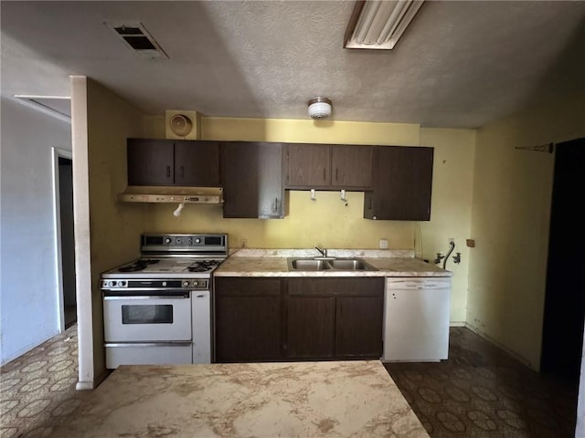 kitchen featuring a sink, white appliances, visible vents, under cabinet range hood, and light countertops
