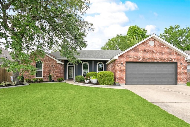 ranch-style house featuring an attached garage, concrete driveway, a shingled roof, a front yard, and brick siding