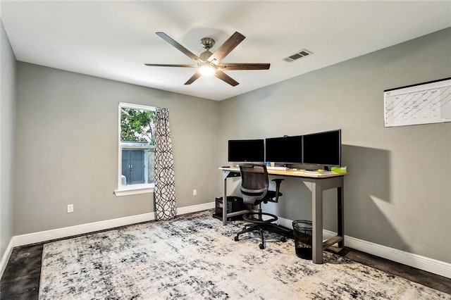 home office with baseboards, visible vents, and a ceiling fan
