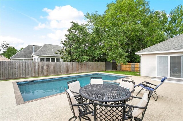 view of swimming pool featuring a patio area, outdoor dining area, a fenced in pool, and a fenced backyard