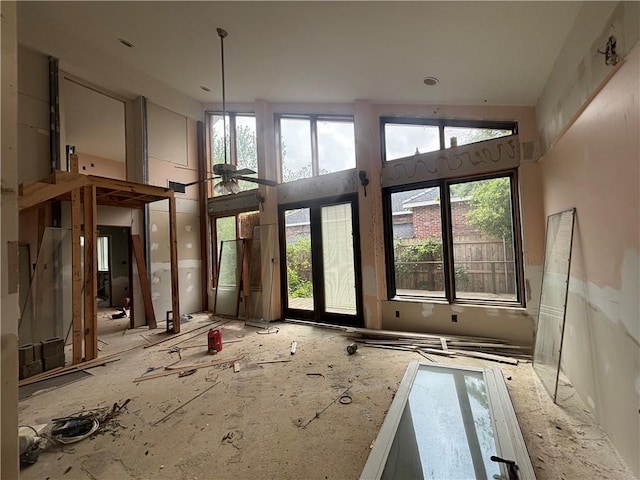 misc room with a high ceiling, ceiling fan, and plenty of natural light
