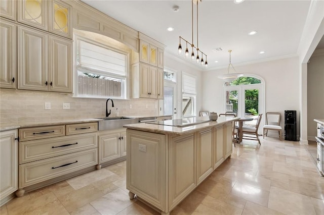 123 N Livingston Pl, Metairie, LA 70005 - kitchen featuring black electric cooktop, decorative backsplash, cream cabinets, and a kitchen island
