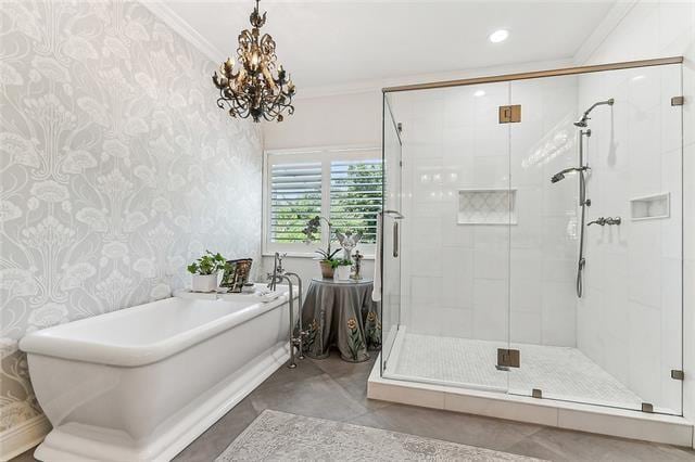 123 N Livingston Pl, Metairie, LA 70005 - bathroom with a stall shower, crown molding, a freestanding bath, a notable chandelier, and wallpapered walls