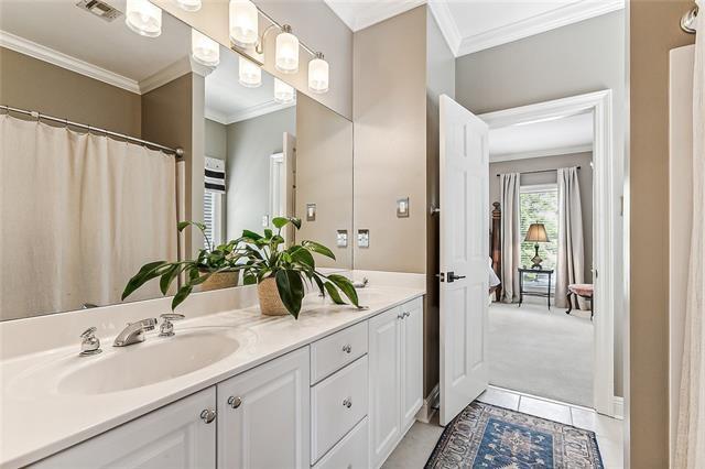 123 N Livingston Pl, Metairie, LA 70005 - bathroom with crown molding, visible vents, a sink, and double vanity