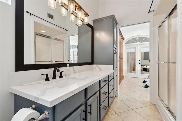 123 N Livingston Pl, Metairie, LA 70005 - bathroom with french doors, a shower with shower door, visible vents, tile patterned flooring, and vanity