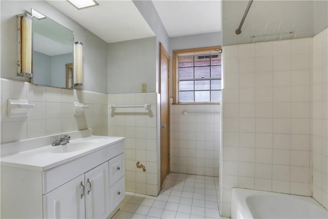 3025 Jefferson Ave, New Orleans, LA 70125 - full bathroom featuring tile walls, tile patterned flooring, vanity, shower / tub combination, and wainscoting