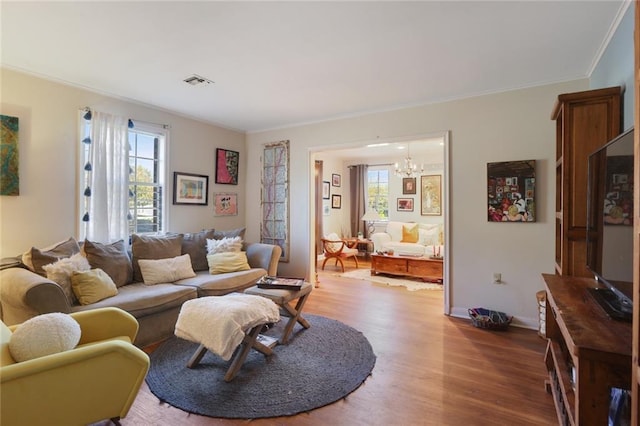 3025 Jefferson Ave, New Orleans, LA 70125 - living area with wood finished floors, a chandelier, ornamental molding, and baseboards