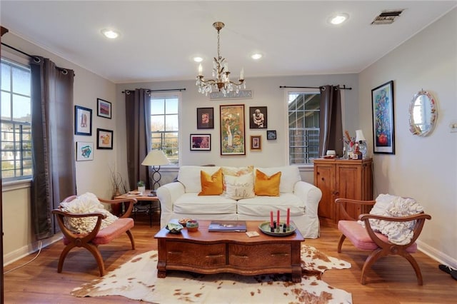 3025 Jefferson Ave, New Orleans, LA 70125 - living room featuring a chandelier, healthy amount of natural light, wood finished floors, recessed lighting, and ornamental molding
