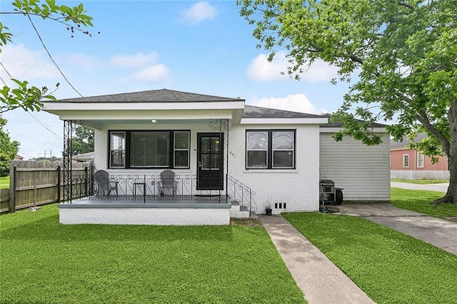 bungalow with a porch, a front lawn, and fence