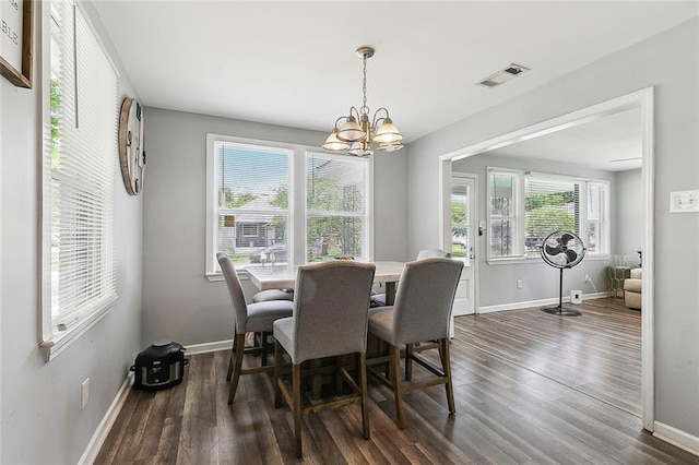 dining space with baseboards, a notable chandelier, dark wood finished floors, and visible vents