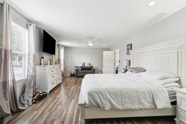 bedroom with recessed lighting, wood finished floors, and multiple windows