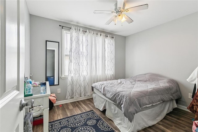 bedroom with baseboards, ceiling fan, and wood finished floors