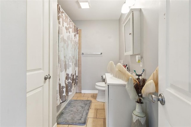 bathroom featuring toilet, a shower with curtain, tile patterned floors, and vanity