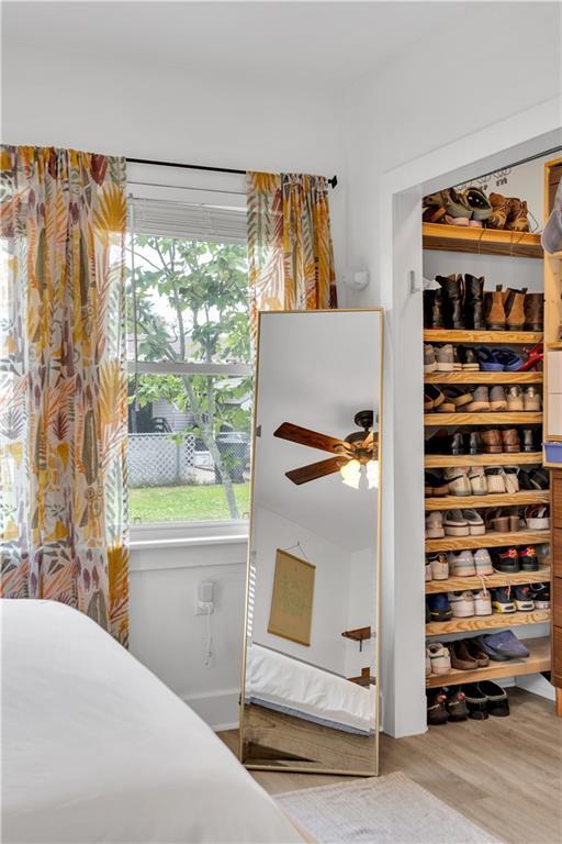bedroom featuring multiple windows and wood finished floors