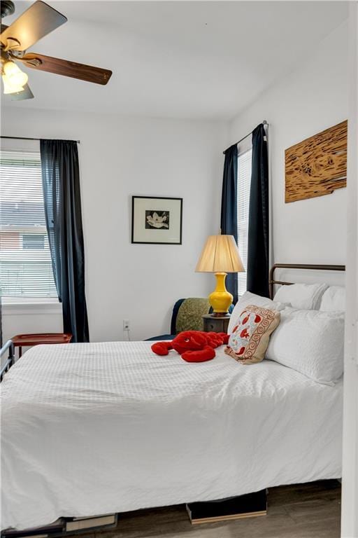 bedroom with a ceiling fan and wood finished floors