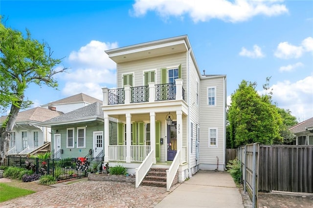 335 Joseph St, New Orleans, LA 70115 - view of front of home with a porch, fence private yard, and a balcony