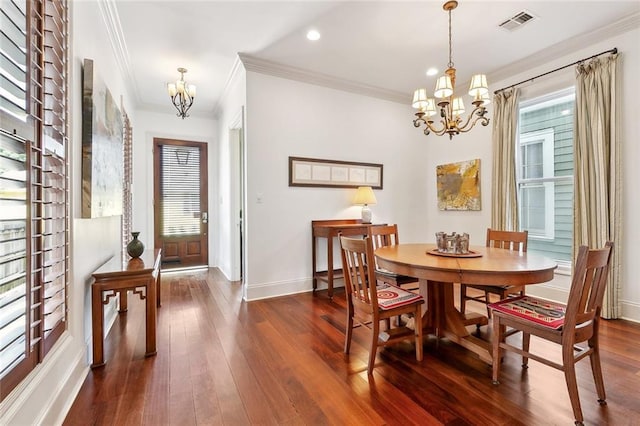 335 Joseph St, New Orleans, LA 70115 - dining room featuring a chandelier, ornamental molding, baseboards, and dark wood finished floors