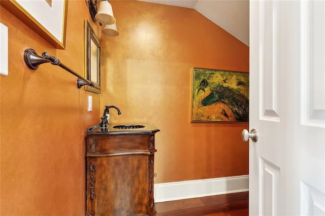 335 Joseph St, New Orleans, LA 70115 - interior space featuring baseboards, lofted ceiling, vanity, and wood finished floors