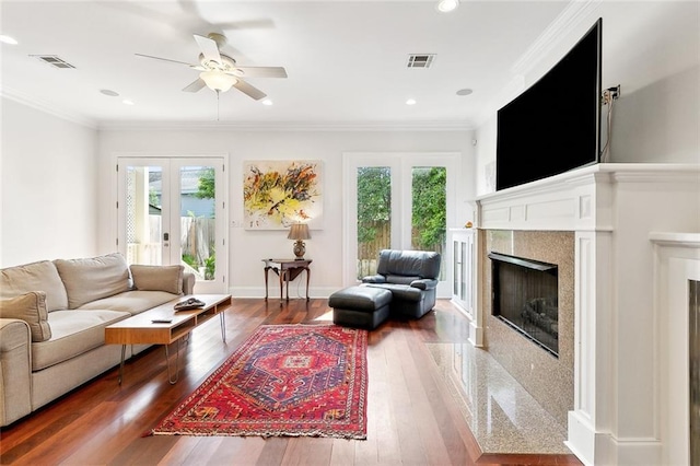 335 Joseph St, New Orleans, LA 70115 - living area with a fireplace, ceiling fan, plenty of natural light, and wood finished floors