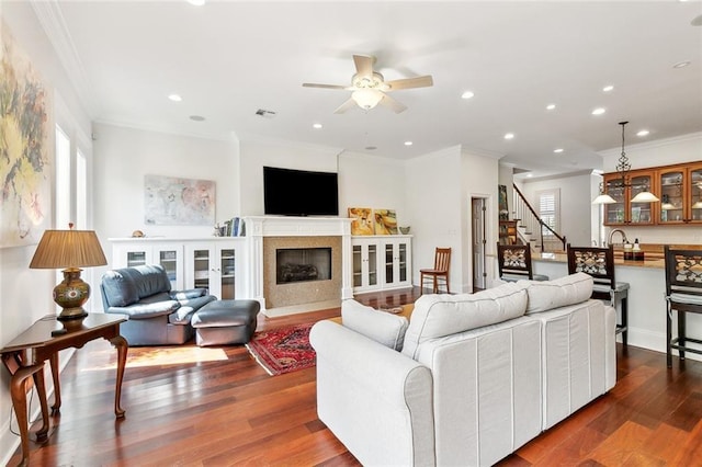 335 Joseph St, New Orleans, LA 70115 - living room featuring crown molding, a ceiling fan, plenty of natural light, and dark wood-type flooring