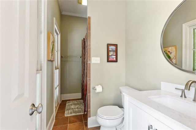 335 Joseph St, New Orleans, LA 70115 - bathroom with toilet, vanity, crown molding, tile patterned flooring, and baseboards