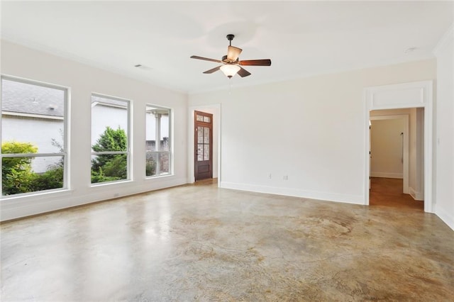 spare room with ceiling fan, finished concrete flooring, baseboards, and visible vents