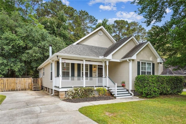 71238 Shady Lake Dr, Covington, LA 70433 - view of front of house featuring fence, a front lawn, concrete driveway, a porch, and roof with shingles