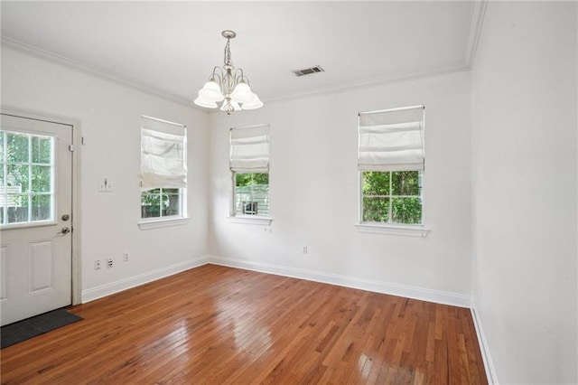 71238 Shady Lake Dr, Covington, LA 70433 - unfurnished dining area with an inviting chandelier, a healthy amount of sunlight, wood-type flooring, and crown molding
