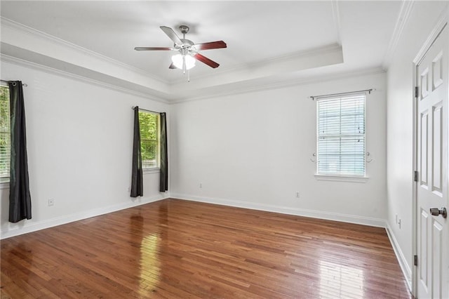 71238 Shady Lake Dr, Covington, LA 70433 - empty room featuring a tray ceiling, crown molding, hardwood / wood-style flooring, and a ceiling fan