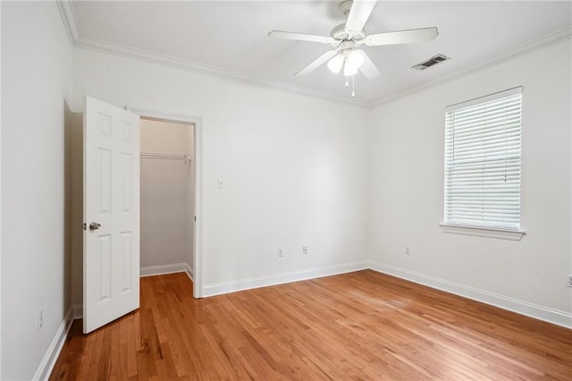 71238 Shady Lake Dr, Covington, LA 70433 - spare room with visible vents, light wood finished floors, crown molding, a ceiling fan, and baseboards