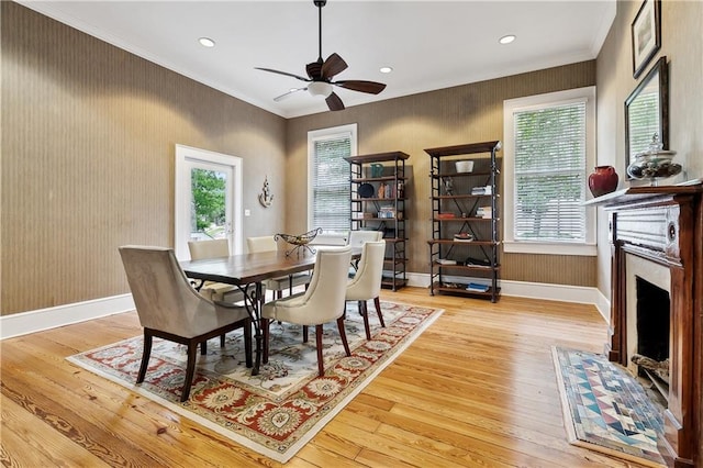 dining room with a fireplace with flush hearth, hardwood / wood-style floors, a ceiling fan, and recessed lighting