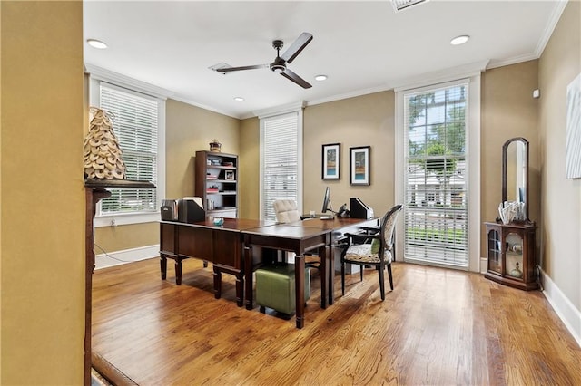 office space featuring wood finished floors, baseboards, and ornamental molding