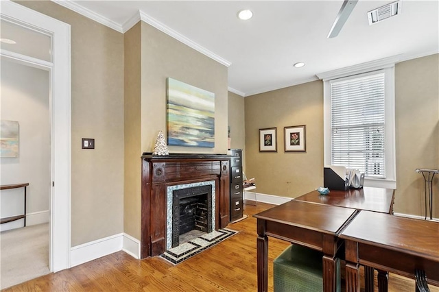 office area featuring crown molding, visible vents, wood finished floors, and baseboards