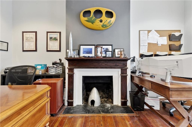 interior space featuring wood finished floors and a fireplace with flush hearth