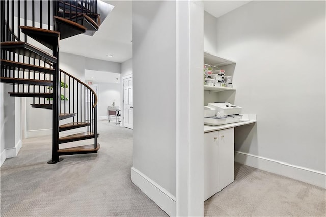 stairway featuring carpet and baseboards