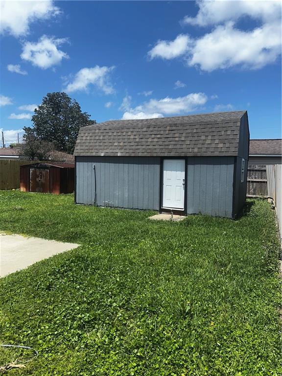 view of shed featuring fence