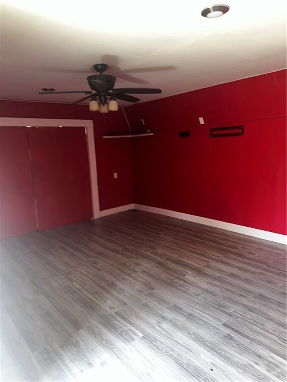 unfurnished room with wood finished floors and ceiling fan