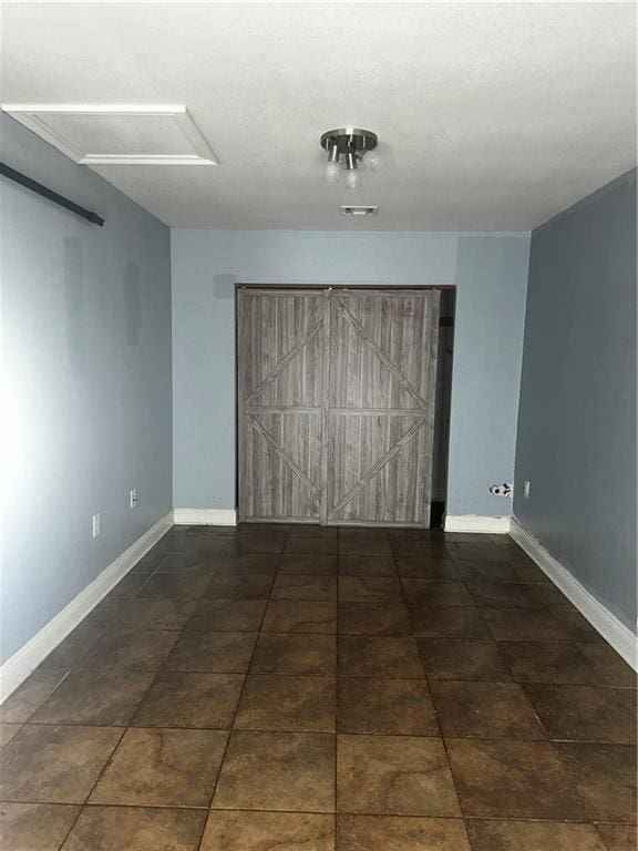 spare room with visible vents and baseboards