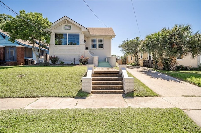 bungalow-style home featuring a front lawn