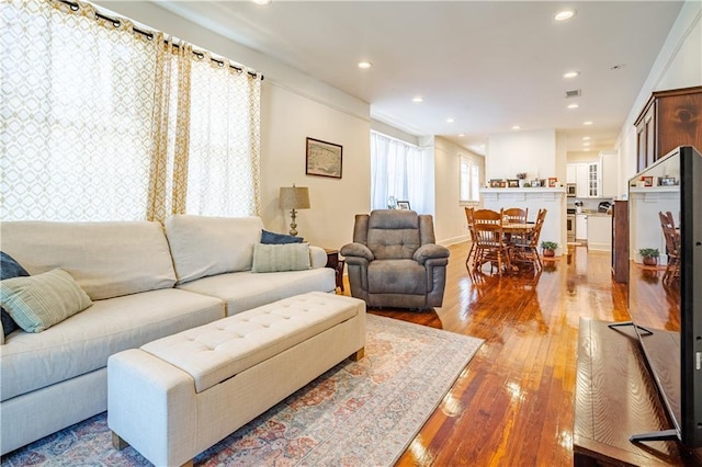 living area featuring light wood-type flooring and recessed lighting