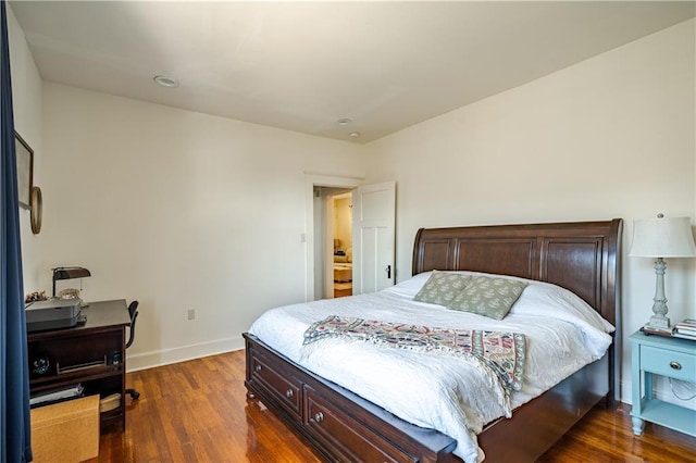bedroom featuring dark wood-style floors, baseboards, and an office area