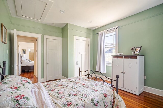 bedroom with attic access, wood finished floors, baseboards, and recessed lighting