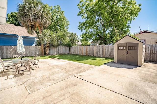 view of patio featuring a storage shed, an outbuilding, and outdoor dining area