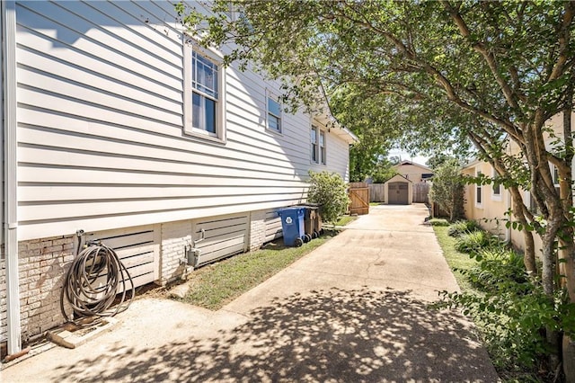 view of side of home featuring fence